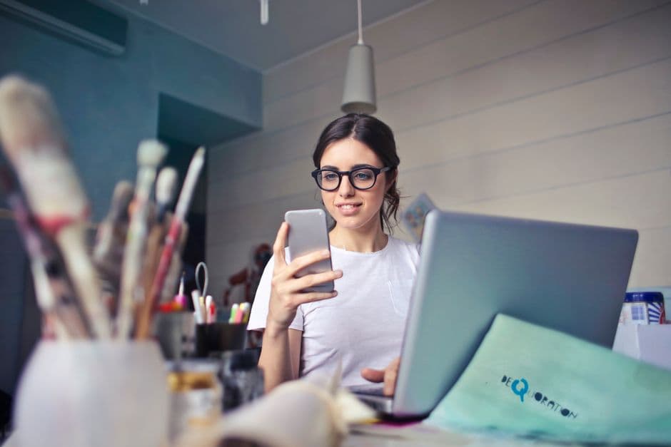 A freelancer working on a laptop in a bright studio