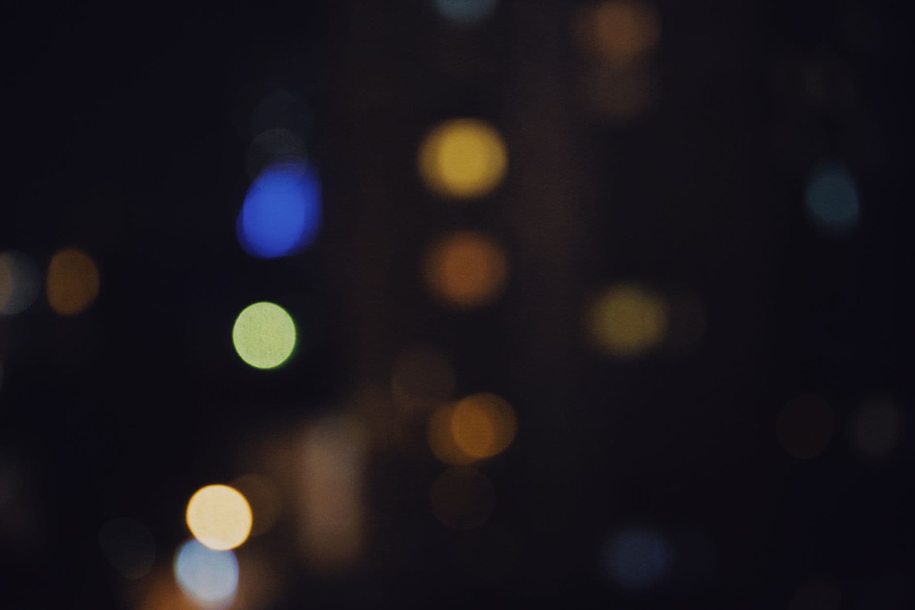 City lights defocused into soft bokeh circles at night